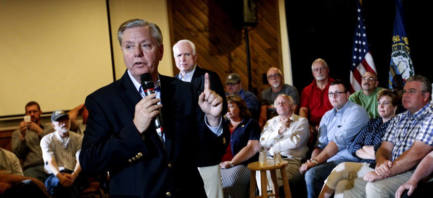 Republican presidential candidate Sen. Lindsey Graham (R-S.C.), front center, campaigns with Sen. John McCain, R- Ariz, back center, as they hold a town hall meeting in Manchester, N.H., Saturday, Aug. 1, 2015.