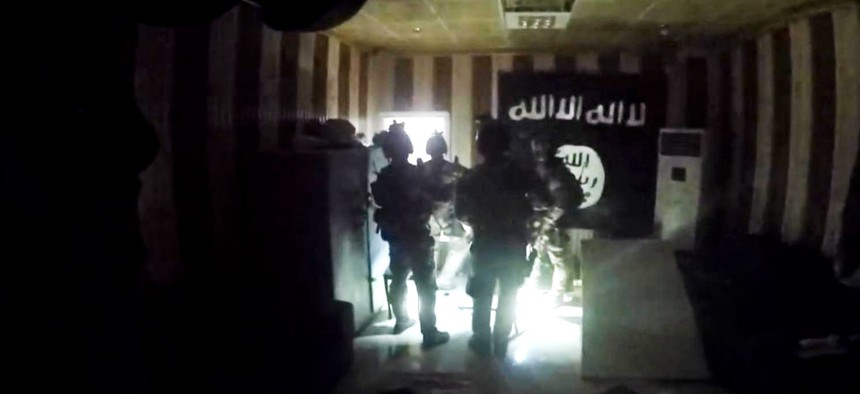 U.S. and Iraqi special forces search for enemy fighters and free dozens of hostages from a makeshift prison in Huwija, Iraq, in this image from helmet cam video taken Oct. 22, 2015.