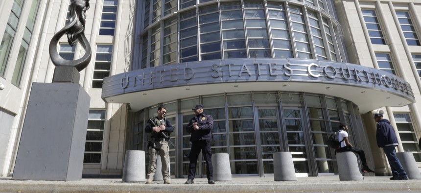 Heavily armed U.S. Marshals stand guard outside federal court Thursday, April 2, 2015, in the Brooklyn borough of New York. 
