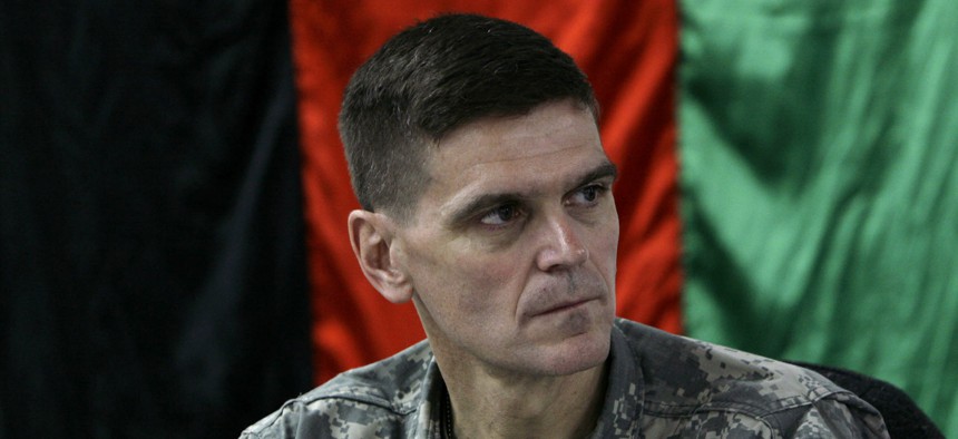 U.S. Brig. Gen. Joseph Votel listens in front of an Afghan national flag during a meeting with Afghan officials in an Afghan military base in Kabul, Afghanistan Sunday, Feb. 24, 2007. 