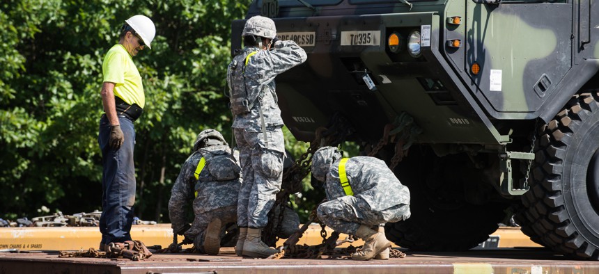 Soldiers of the 10th Mountain Division work with a civilian during railhead operations at Fort Drum, N.Y., July 28, 2015.