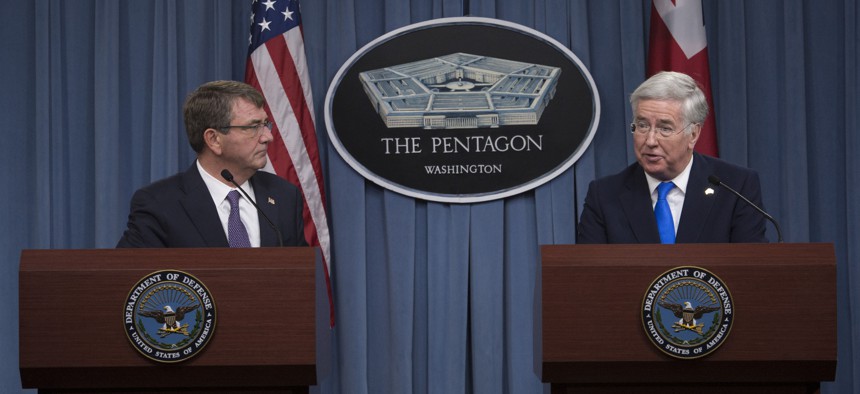 U.S. Defense Secretary Ash Carter and British Defense Secretary Michael Fallon conduct a joint news conference at the Pentagon, Dec. 11, 2015. 