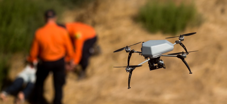 A drone flies over a ravine as the Alameda County Sheriff's Office demonstrates a search and rescue operation, Friday, Aug. 14, 2015, in Dublin, Calif.