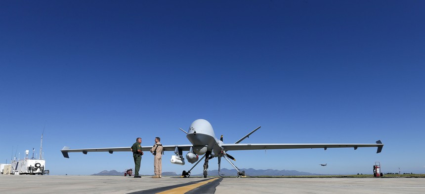 Lothar Eckardt, right, executive director of National Air Security Operations at U.S. Customs and Border Protection, speaks with a Customs and Border Patrol agent prior to a drone aircraft flight, Wednesday, Sept 24, 2014.