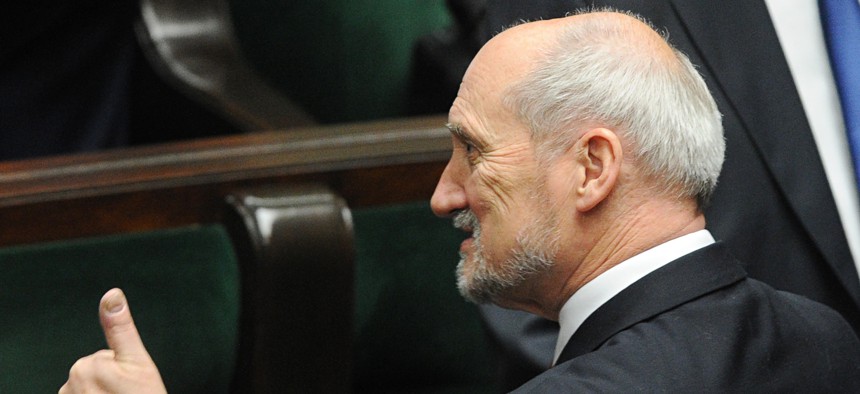 Then candidate for the new defense minister Antoni Macierewicz gives his thumb up before the opening of the first session of the new parliament in Warsaw, Poland, Thursday, Nov. 12, 2015.