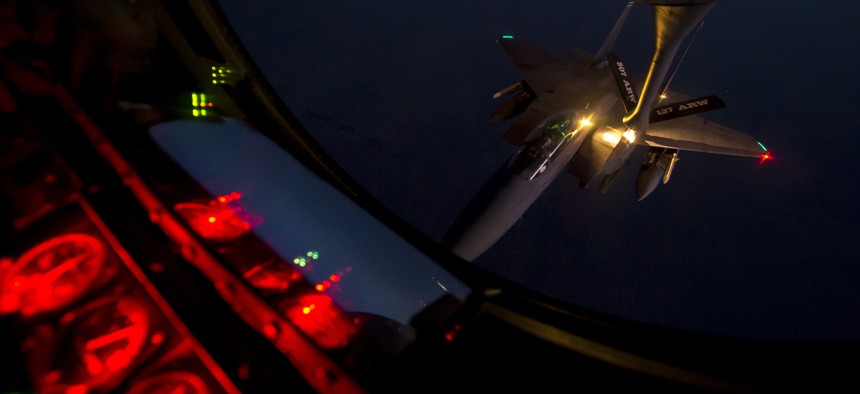 A U.S. Air Force F-15E Strike Eagle aircraft refuels from a KC-135 Stratotanker aircraft over northern Iraq Sept. 23, 2014, after conducting airstrikes in Syria.