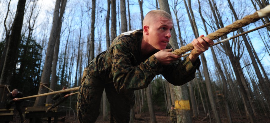 A Marine Officer Candidates School troop maneuvers down a horizontal rope on Dec. 9, 2011, at Marine Corps Base Quantico, Va.