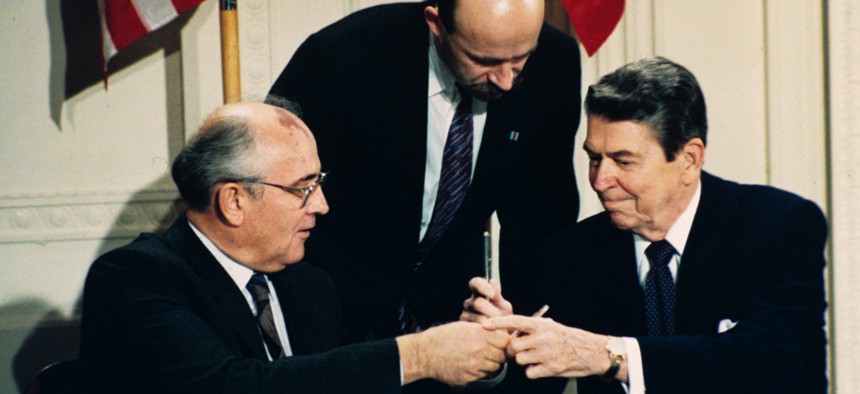 In this Dec. 8, 1987 file photo U.S. President Ronald Reagan, right, and Soviet leader Mikhail Gorbachev exchange pens during the Intermediate Range Nuclear Forces Treaty signing ceremony in the White House East Room in Washington, D.C. 