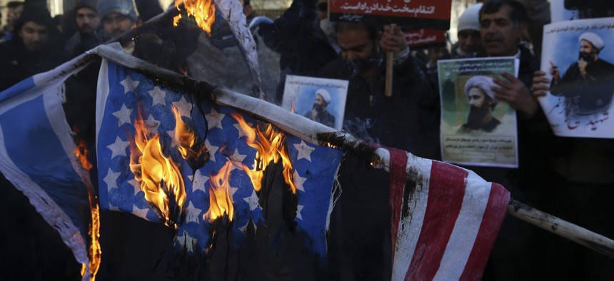 In this Sunday, Jan. 3, 2016 file photo, Iranian demonstrators burn representations of the U.S. and Israeli flags during a demonstration in front of the Saudi Arabian Embassy in Tehran, Iran.