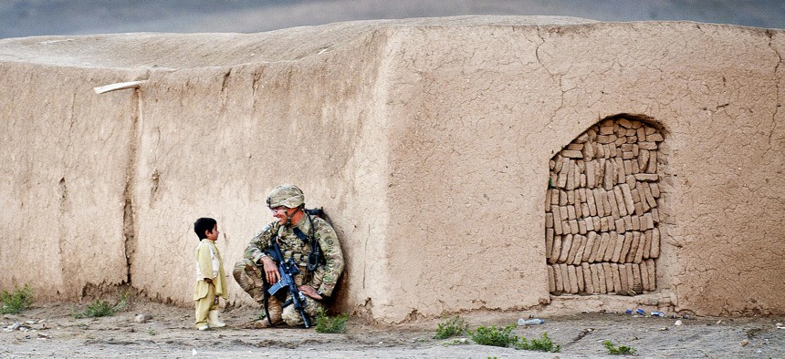 Sgt. Joshua Smith, a paratrooper with the 82nd Airborne Division’s 1st Brigade Combat Team, chats with an Afghan boy during an Afghan-led clearing operation April 28, 2012, Ghazni province, Afghanistan.