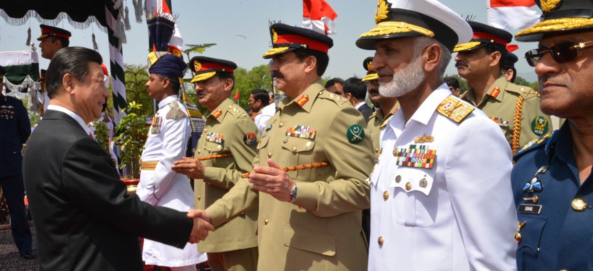 In this April 20, 2015, file photo provided by Pakistan's Press Information Department, Chinese President Xi Jinping, left, shakes hands with Pakistan's army chief Gen. Raheel Sharif, at Nur Khan airbase in Islamabad, Pakistan.