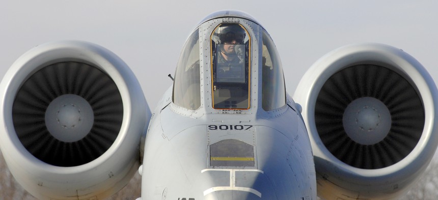 A pilot with the 442nd Fighter Wing sits on the ramp in a U.S. Air Force A-10 Thunderbolt II aircraft while crew chiefs perform a hot pit refuel for his aircraft at Whiteman Air Force Base, Mo., Dec. 8, 2010. 