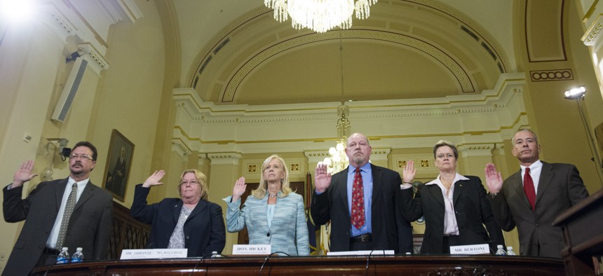 Witnesses are sworn-in before testifying to the House Committee on Veterans' Affairs hearing to review the Veterans Benefits Administrations progress in ending its disability compensation claims backlog by 2015, on Capitol Hill, Monday, July 14, 2014.