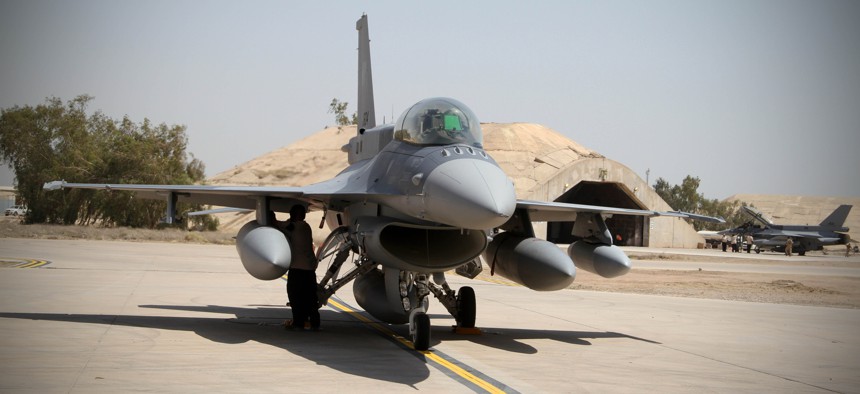 Two of four new U.S.- made F-16 fighter jets stand on the tarmac upon their arrival to Balad air base, 75 kilometers (45 miles) north of Baghdad, Iraq, Monday, July 13, 2015. 
