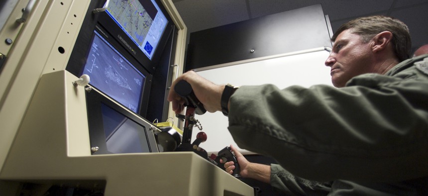 A U.S. Air Force officer pilots a training simulator for the MQ-1 Predator, at the March Air Reserve Base in Riverside County, Calif., June 25, 2008. 