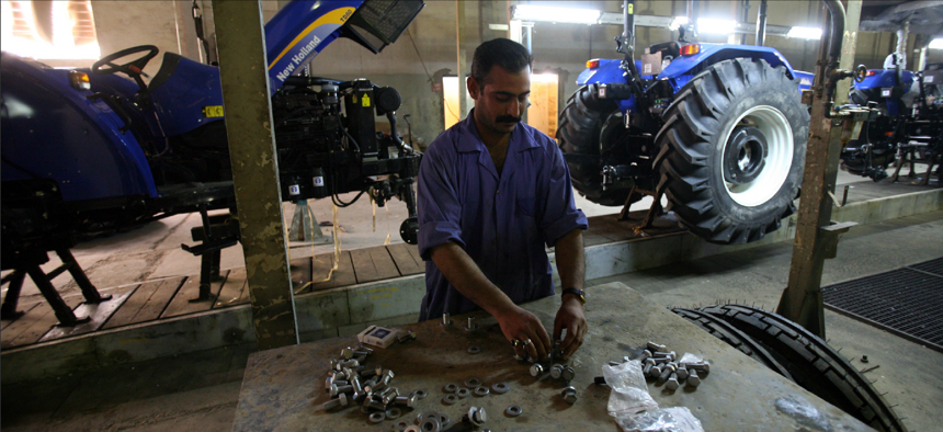 A worker assembles parts at a factory of the State Company for Mechanical Industry in Iskandiriyah, Iraq, one of many companies that TFBSO helped draw investors to.