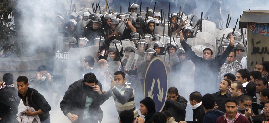 In this Friday, Jan. 28, 2011 file photo, Egyptian anti-government activists clash with riot police in Cairo, Egypt.