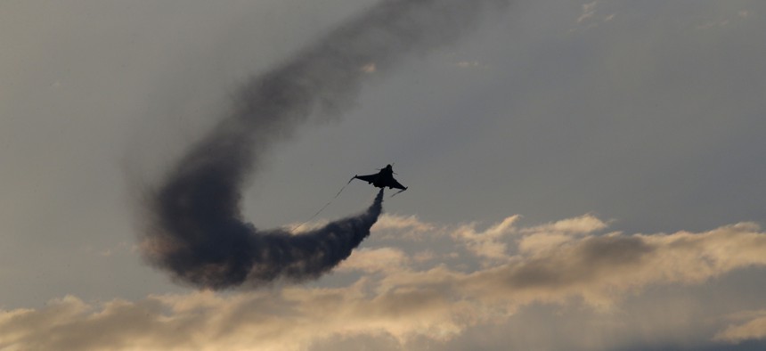 A Rafale fighter jet dumps fuel after a mission, before landing on France's flagship Charles de Gaulle aircraft carrier in the Persian Gulf, Tuesday, Jan. 12, 2016. 