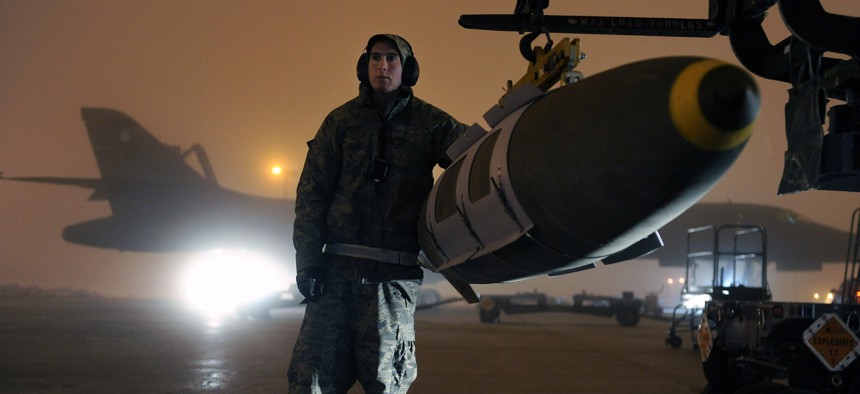 An Airman steadies a GBU-31 joint direct attack munition while preparing to load it on a B-1B Lancer on Ellsworth Air Force Base, S.D., March 27, 2011.