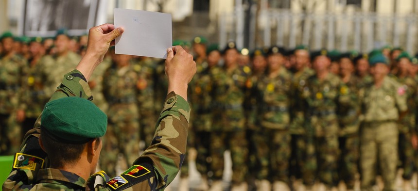 An Afghan National Army soldier holds up his diistinguished graduate certificate during the 3rd term graduation oath ceremony at Ghazi Military Training Center in Kabul, Afghanistan.