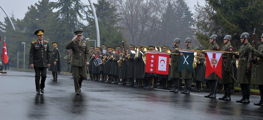 Chairman of the U.S. Joint Chiefs of Staff, Gen. Joseph Dunford, second left, and Turkey's Chief of Staff Gen. Hulusi Akar inspect a military honour guard in Ankara, Turkey, on Jan. 6, 2016.
