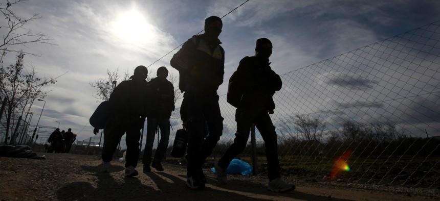 Refugees walk towards the border with Serbia from the transit center for refugees near northern Macedonian village of Tabanovce, Friday, Feb. 5, 2016.