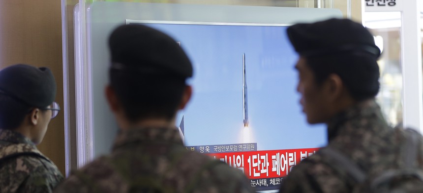 South Korean army soldiers watch a TV news program with file footage about North Korea's rocket launch at Seoul Railway Station in Seoul, South Korea, on Feb. 7, 2016.