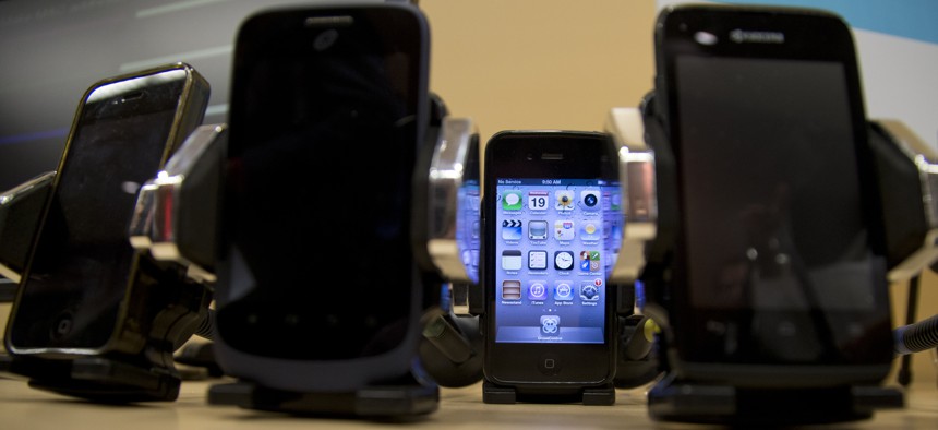 Cell phones are displayed during a Federal Trade Commission (FTC) mobile tracking demo, Wednesday, Feb. 19, 2014, in Washington.