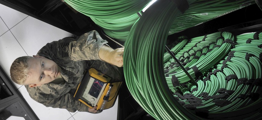 A U.S. Air Force cyber-transport technician checks network routers at the Defense Media Activity’s Headquarters at Fort Meade, Md., July 18, 2012.