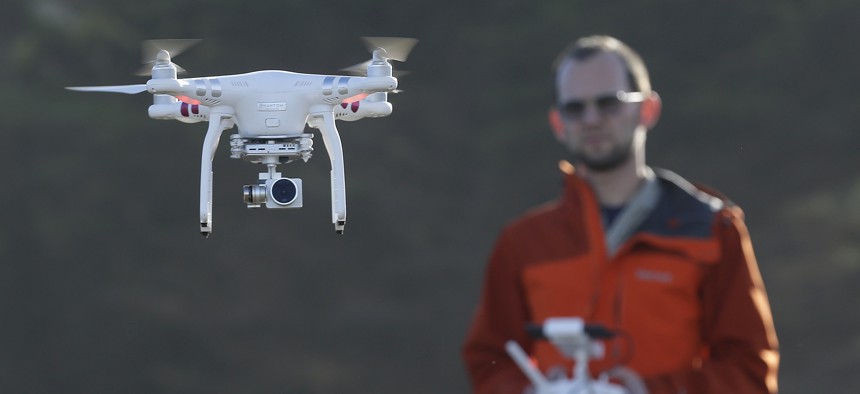 In this Thursday, Jan. 21, 2016 photo, Trent Lukaczyk, an unmanned aerial vehicle (UAV) engineer who builds and flies drones to monitor changes in the ocean environment, controls a DJI Phantom 3 Advanced drone to take photos and videos over the coastline 