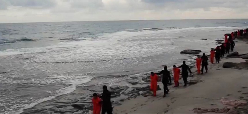 This image made from a video released Sunday Feb. 15, 2015 by militants in Libya claiming loyalty to the Islamic State group before beheading Egyptian Coptic Christians.