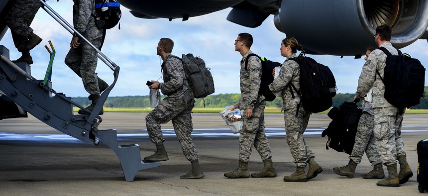 U.S. Air Force airmen assigned to the 633rd Medical Group load onto a C-17 Globemaster at Langley Air Force Base, Va., in 2014, helping to deliver a modular medical treatment center to Ebola-stricken countries.