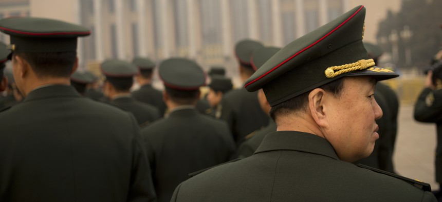 Delegates from the Chinese People's Liberation Army (PLA) arrive at the Great Hall of the People in Beijing, Friday, March 4, 2016. China said Friday it will boost military spending by about 7 to 8 percent this year, the smallest increase in six years.