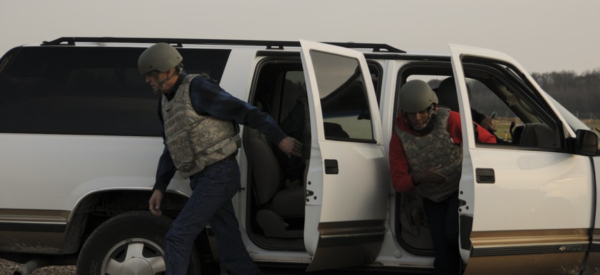 Two civilians rehearse exiting a vehicle under attack at Muscatatuck Training Range, an extension of Camp Atterbury Joint Maneuver Training Center in Edinburgh, Ind., Nov. 7, 2012.