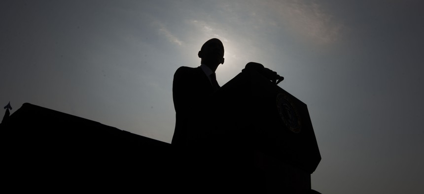 President Barack Obama is silhouetted as he speaks on stage at the Pentagon Memorial, Wednesday, Sept. 11, 2013, in Washington, to mark the 12th anniversary of the 9/11 attacks. 