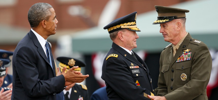 President Barack Obama watches as newly sworn-in Joint Chiefs Chairman Gen. Joseph Dunford Jr., right, shakes hands with retiring Joint Chiefs Chairman Gen. Martin Dempsey during his Armed Forces Full Honors Retirement Ceremony for Dempsey, Friday, Sept. 