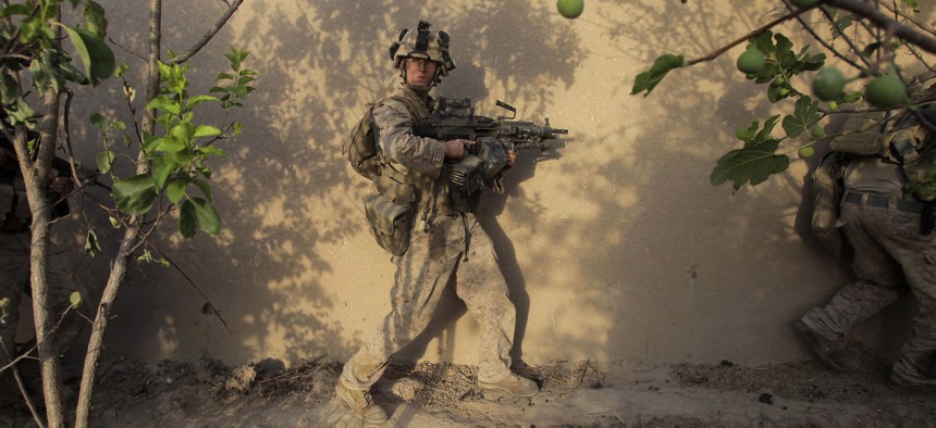 United States Marines from Golf Company, 2nd Battalion, 3rd Regiment, 2nd MEB, move through a compound in the village of Dahaneh during a raid Saturday, Aug. 15, 2009, in the Helmand Province of Afghanistan. 