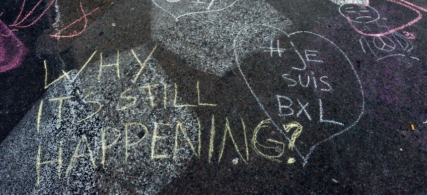 Solidarity messages are written in chalk outside the stock exchange in Brussels on Tuesday, March 22, 2016.