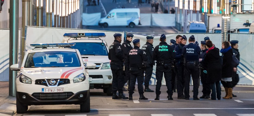 Police stand outside a metro station after an explosion in Brussels on Tuesday, March 22, 2016.