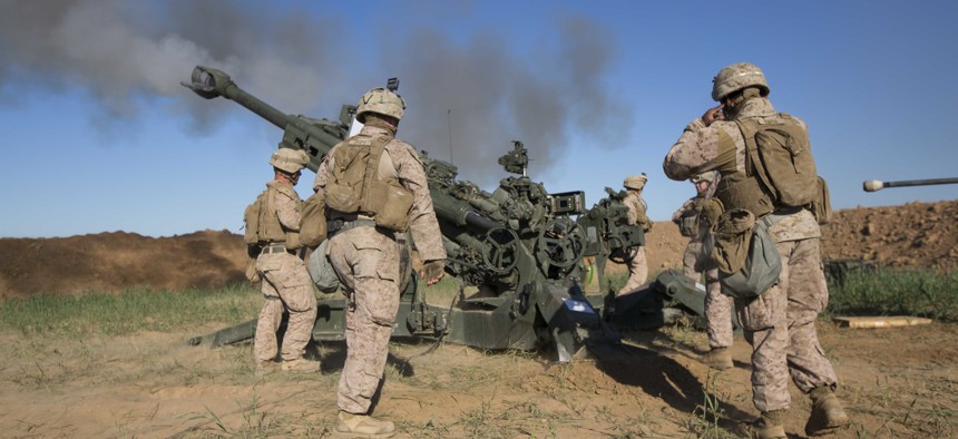 U.S. Marines with Task Force Spartan, 26th Marine Expeditionary Unit (MEU), on Fire Base Bell, Iraq, fire an M777A2 Howitzer at an ISIS infiltration route March 18, 2016. 