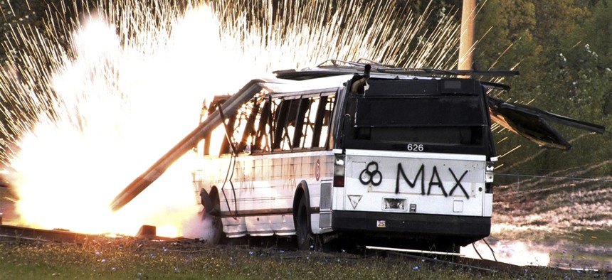 In this photo made from video a simulated radioactive "dirty bombs" explodes on a bus which was used to test the ability of federal and local agencies to deal with a real terrorist attack Tuesday, Oct 16, 2007, in Portland, Ore.