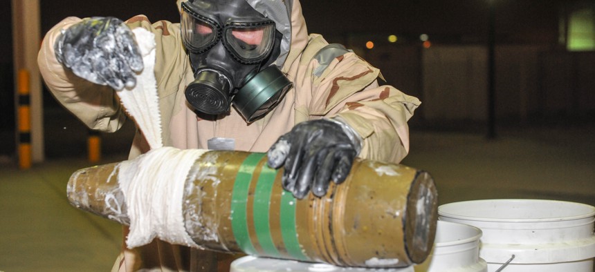 An EOD expert wraps the ordinance in an attempt to seal a ‘dirty bomb,’ so that it will not continue to leak out hazardous material, June 3, 2013.