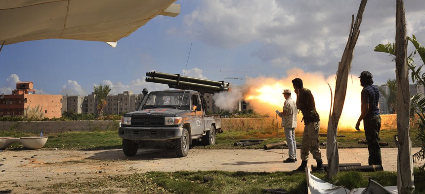 Libyan revolutionary fighters launch a missile towards pro-Gadhafi forces in downtown Sirte, Libya, Friday, Oct. 14, 2011.