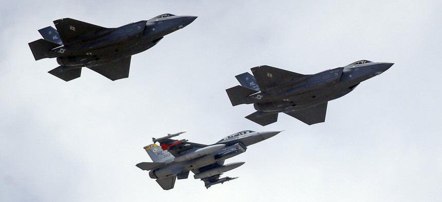 An F-16, below, escorts two F-35 jets, above, after arriving at it new operational base Wednesday, Sept. 2, 2015, at Hill Air Force Base, in northern Utah.