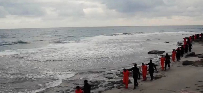 n this file image made from a video released Sunday, Feb. 15, 2015 by militants in Libya claiming loyalty to the Islamic State group purportedly shows Egyptian Coptic Christians in orange jumpsuits being led along a beach.
