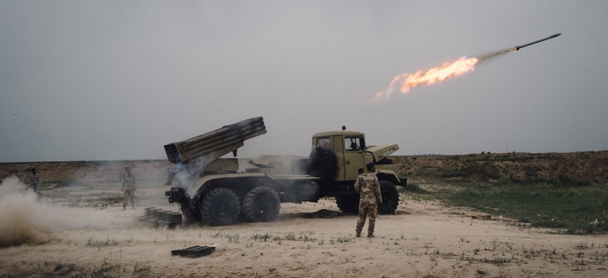 A rocket is fired from a rocket launcher outside Makhmour, about 75 km (47 miles) east of Mosul, Iraq, Friday, March 25, 2016.