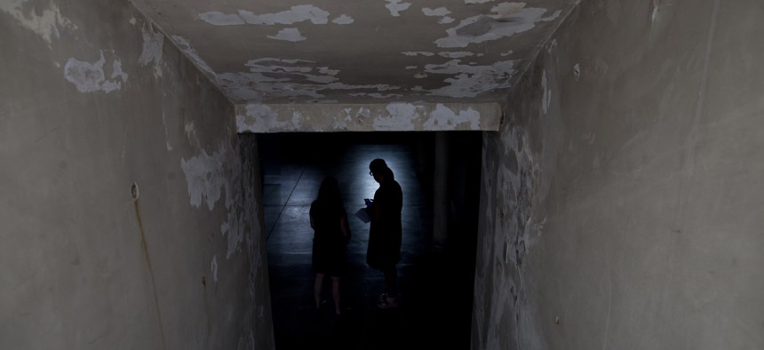 Women stand inside the basement that served as an admitting area for detainees at the former torture and killing center known as the Argentine Navy School of Mechanics, in Buenos Aires, Argentina, March 16, 2016.
