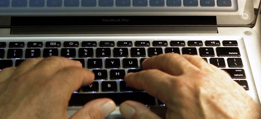 In this Feb. 27, 2013, file photo illustration, hands type on a computer keyboard in Los Angeles.