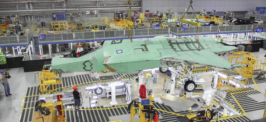 Norway's first F-35 is lifted by an overhead crane in Lockheed Martin's assembly plant in Fort Worth in April 2015.