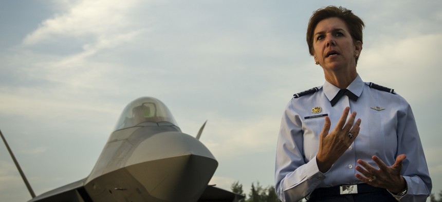 Gen. Lori Robinson, then-Pacific Air Forces commander, addresses U.S. and Singapore Airmen in front of an F-22A Raptor during the Singapore International Airshow, at Changi International Airport, Singapore, Feb. 17, 2016.